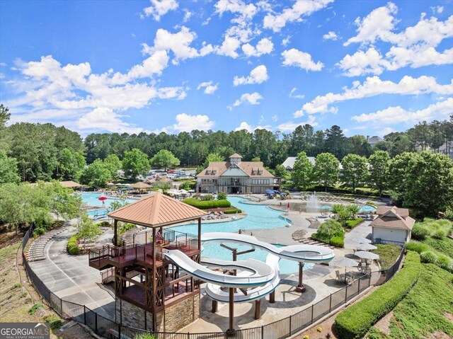 view of swimming pool with a patio and a water slide