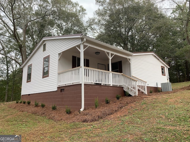 exterior space with central AC unit and a front yard