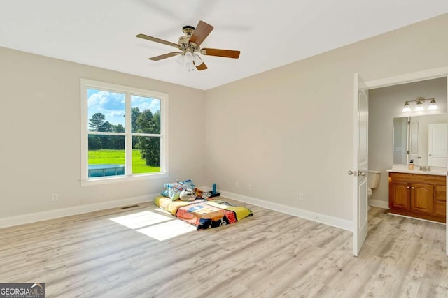 recreation room featuring ceiling fan and light hardwood / wood-style flooring