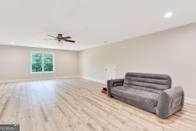 living area featuring ceiling fan and light hardwood / wood-style flooring