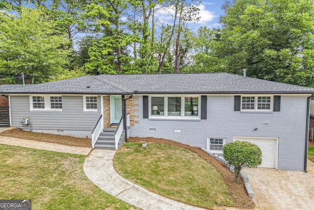 view of front of house with a garage and a front yard