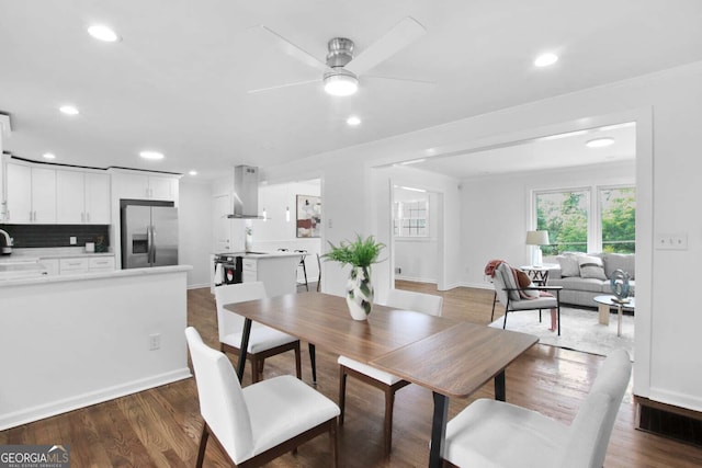 dining area featuring ceiling fan, sink, and dark hardwood / wood-style floors