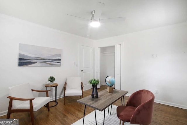 home office with ceiling fan and dark hardwood / wood-style flooring