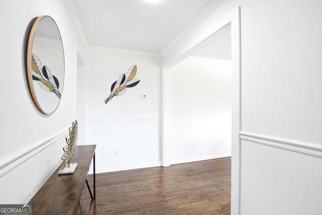 corridor featuring crown molding and dark hardwood / wood-style floors