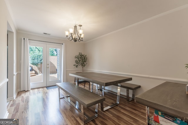 dining room featuring ornamental molding, french doors, hardwood / wood-style floors, and an inviting chandelier