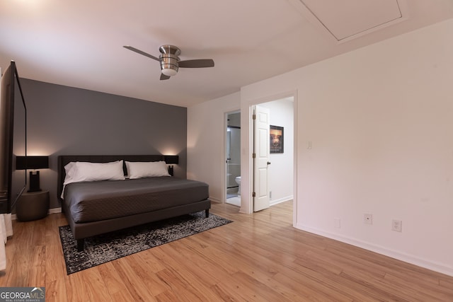 bedroom with connected bathroom, light hardwood / wood-style flooring, and ceiling fan