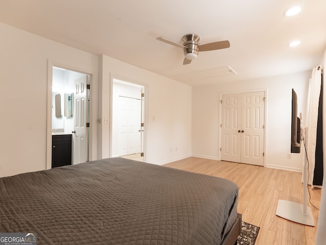 unfurnished bedroom with ensuite bathroom, ceiling fan, and light wood-type flooring