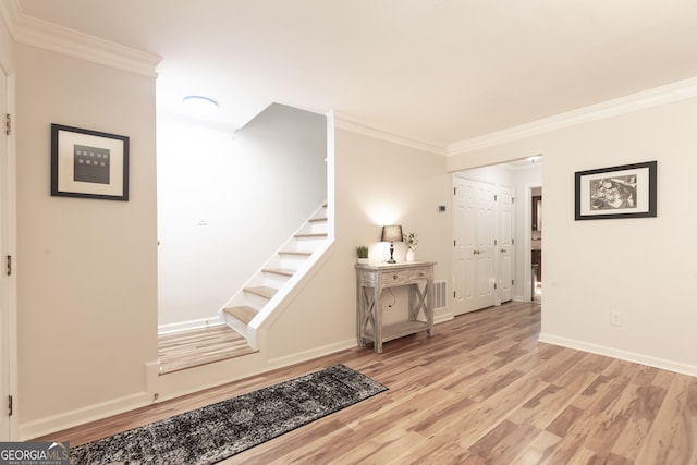 interior space featuring hardwood / wood-style flooring and ornamental molding