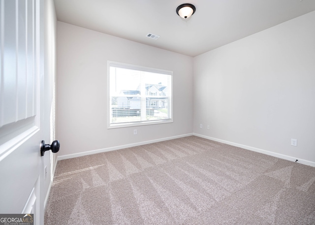 unfurnished room with light carpet