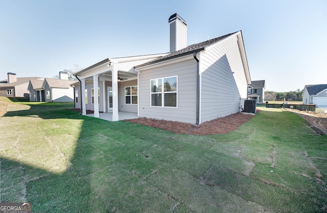 back of house featuring a yard, a patio, and central AC