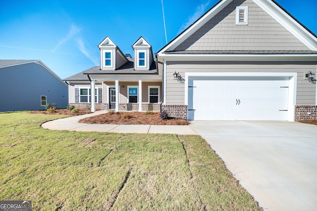 view of front facade featuring a front yard, a porch, and a garage