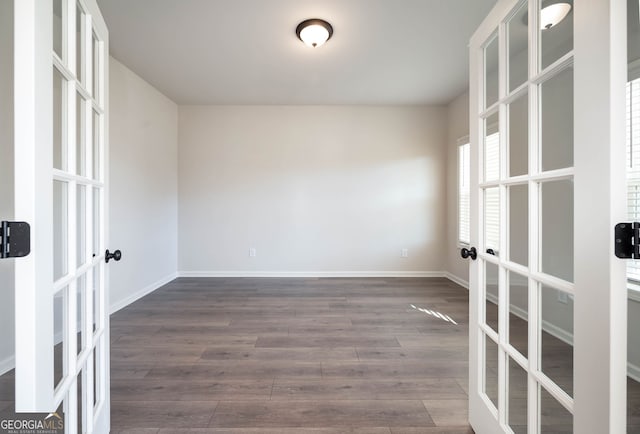 unfurnished room with french doors, dark hardwood / wood-style flooring, and plenty of natural light