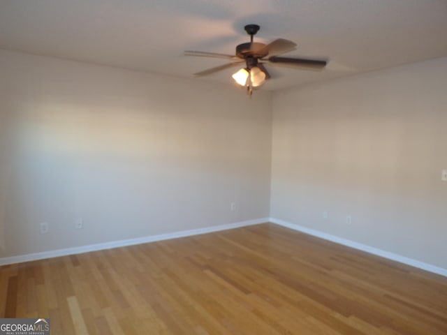 spare room featuring ceiling fan and light hardwood / wood-style floors