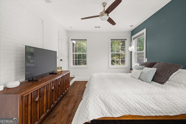 bedroom with ceiling fan and dark wood-type flooring