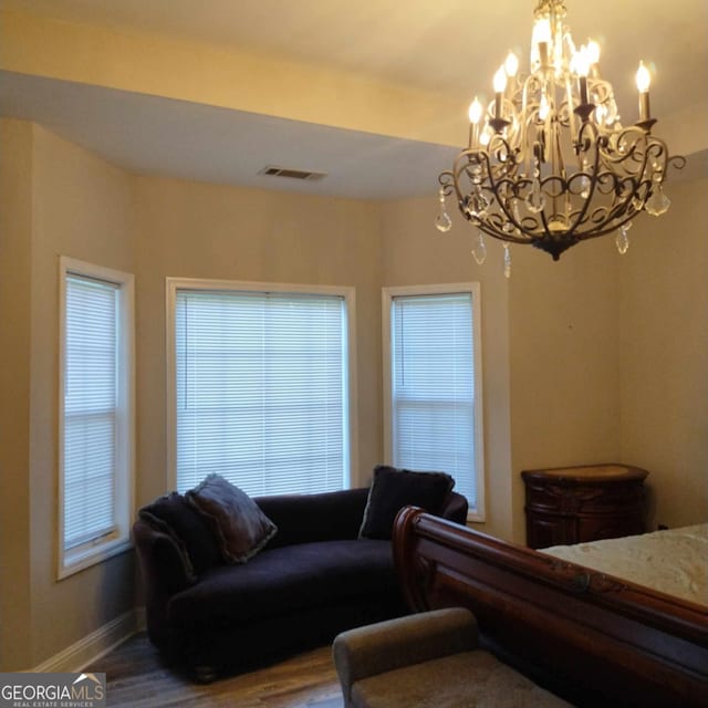 bedroom featuring a chandelier and hardwood / wood-style floors