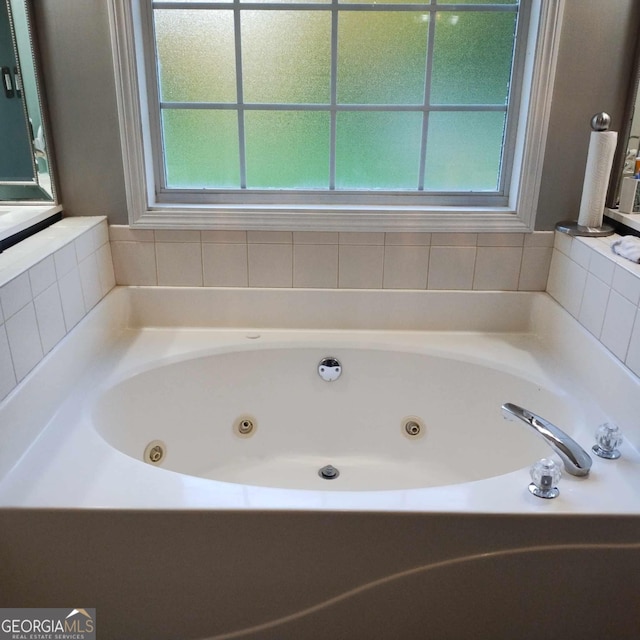 bathroom with a washtub and a wealth of natural light