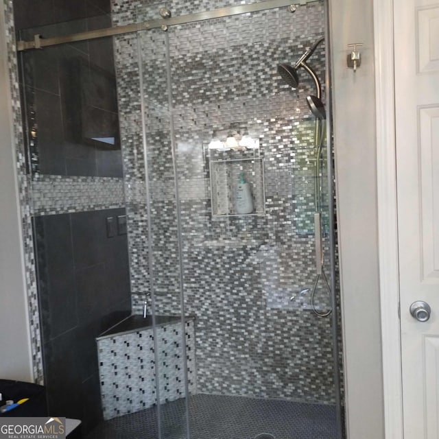 bathroom featuring a shower with shower door