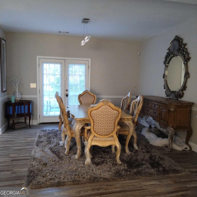 dining room with french doors and dark wood-type flooring