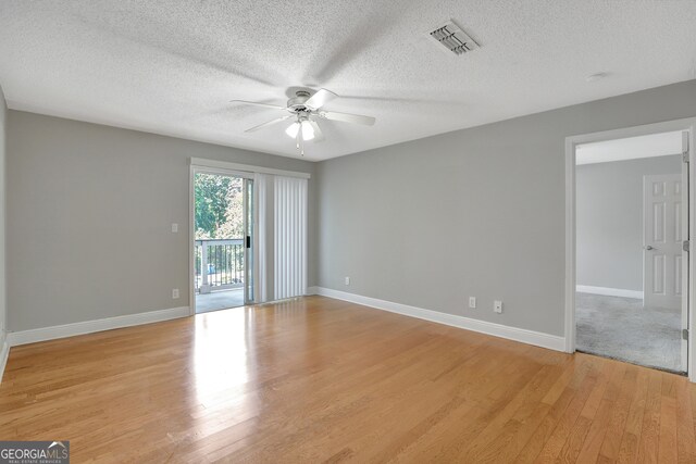 spare room featuring a textured ceiling, ceiling fan, and light hardwood / wood-style floors