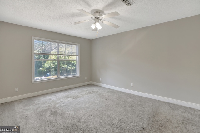 carpeted empty room featuring a textured ceiling and ceiling fan