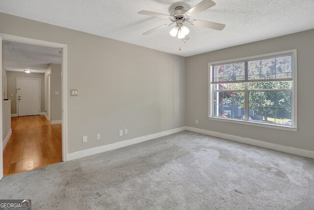 spare room featuring a textured ceiling, ceiling fan, and hardwood / wood-style floors