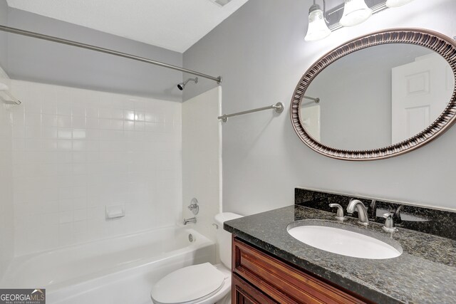 full bathroom with tiled shower / bath combo, vanity, and toilet