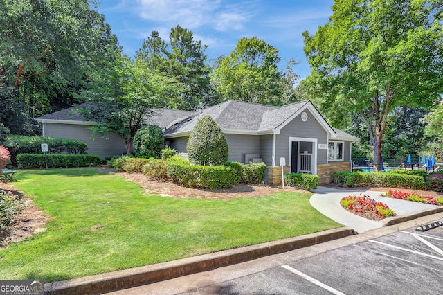 ranch-style house with a front lawn