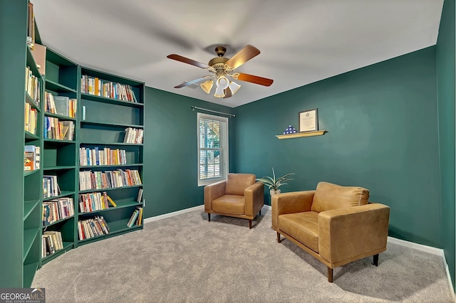 living area featuring ceiling fan and light colored carpet