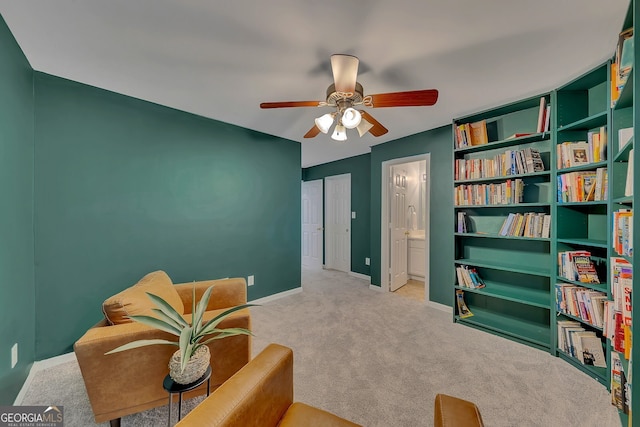 sitting room featuring ceiling fan and light colored carpet