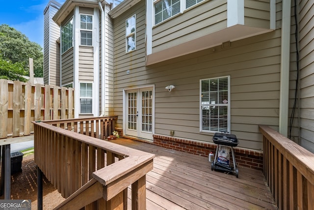 wooden terrace featuring a grill