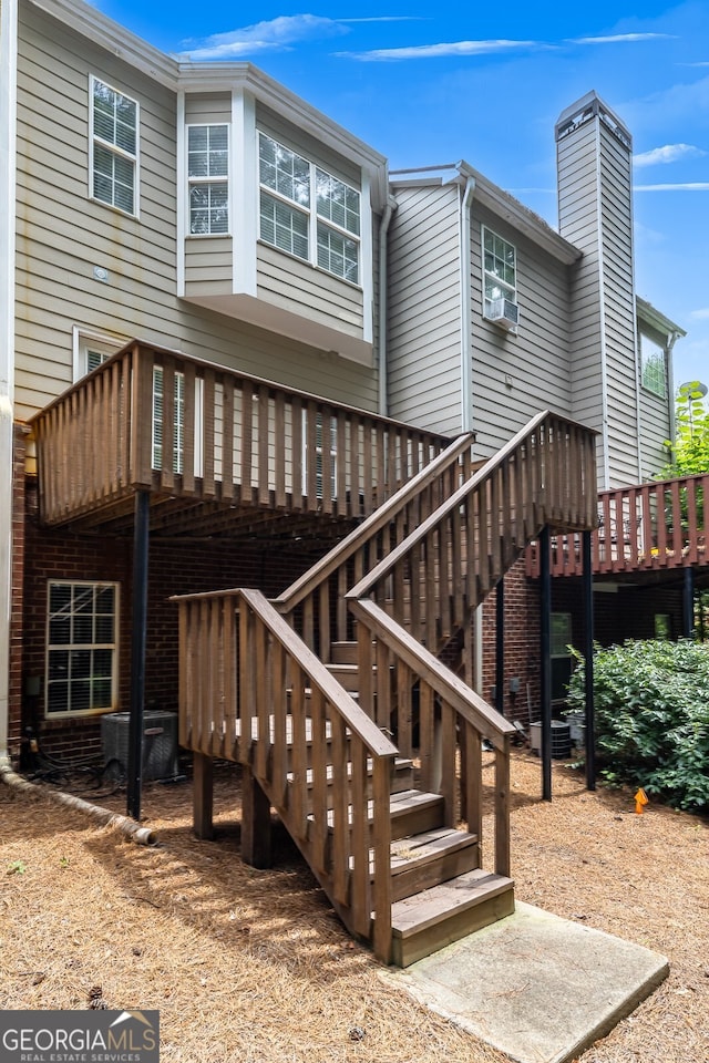 exterior space with central AC and a wooden deck