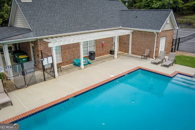 view of pool with a pergola and a patio area