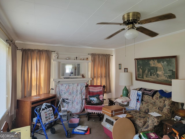 living room featuring carpet, a ceiling fan, and crown molding