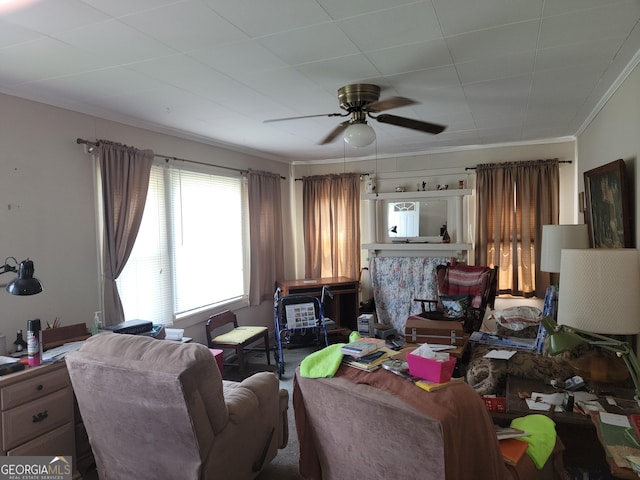 living area featuring ornamental molding and ceiling fan