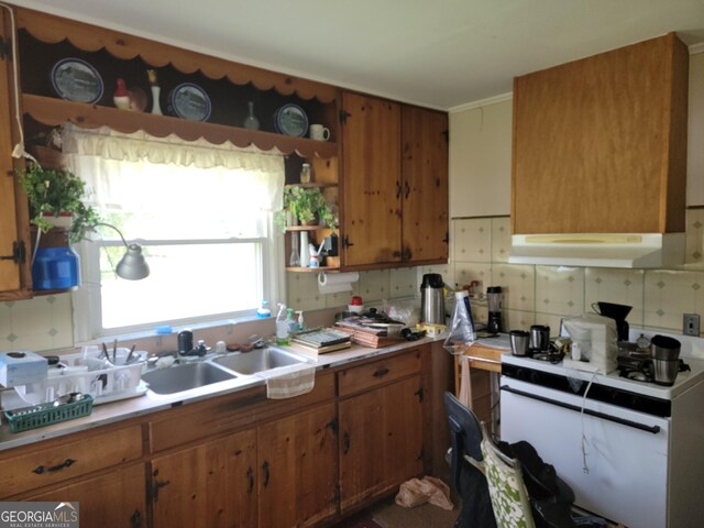 kitchen with open shelves, under cabinet range hood, brown cabinetry, and backsplash