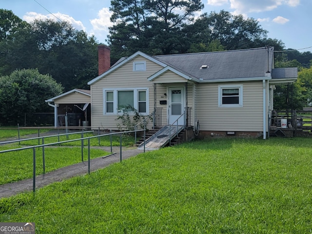 bungalow-style house featuring entry steps, a shingled roof, fence, a carport, and a front lawn