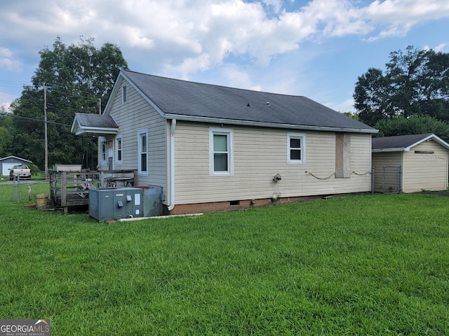 back of house featuring crawl space and a yard