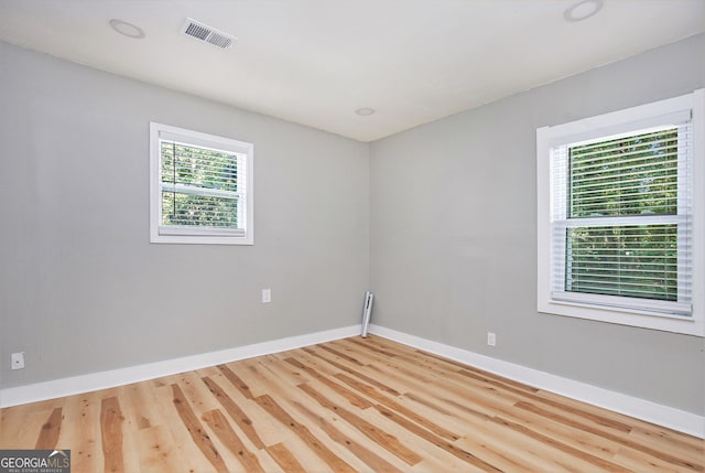 unfurnished room with hardwood / wood-style flooring