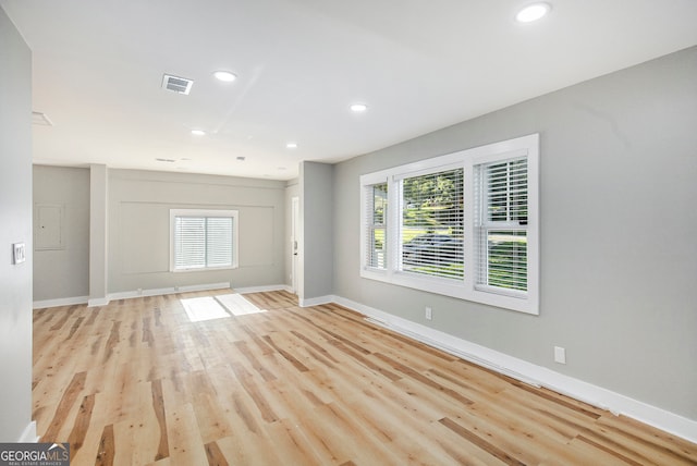 unfurnished living room featuring light wood-type flooring and plenty of natural light