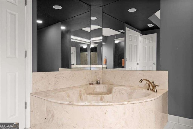 bathroom featuring visible vents and a bath