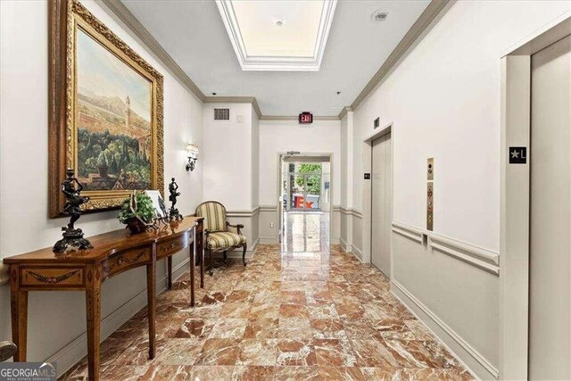 corridor with elevator, visible vents, and crown molding