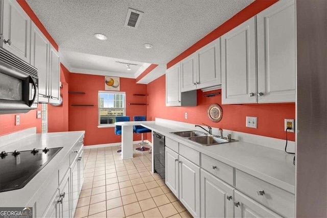 kitchen with light countertops, visible vents, a sink, a textured ceiling, and black appliances