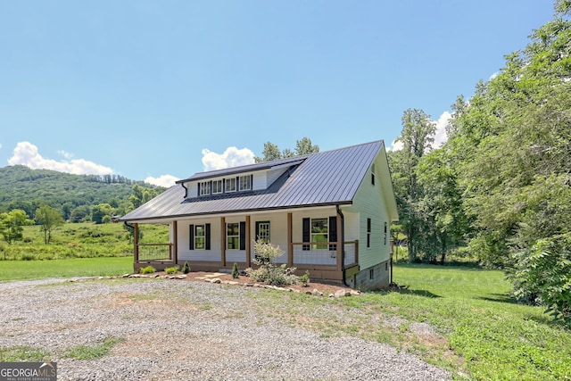 view of front of home with a porch and a front yard