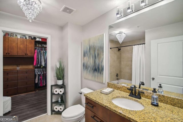 full bathroom with a chandelier, vanity, toilet, and shower / tub combo with curtain