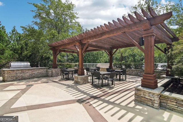 view of patio featuring area for grilling and a pergola