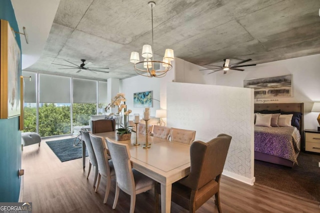 dining area featuring hardwood / wood-style floors and a chandelier