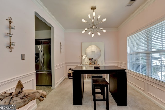 dining room featuring light colored carpet, an inviting chandelier, and ornamental molding