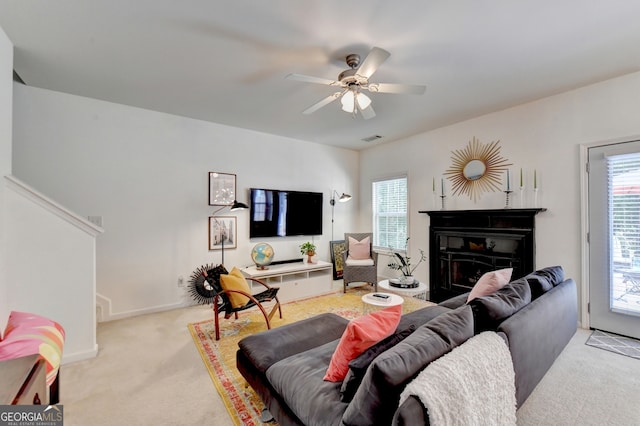 living room featuring light colored carpet and ceiling fan