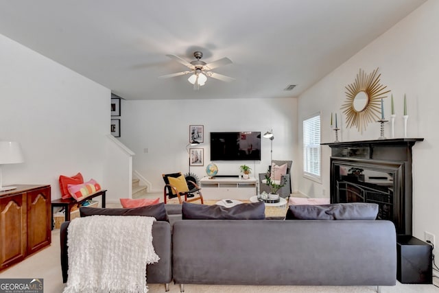 living room with light carpet and ceiling fan