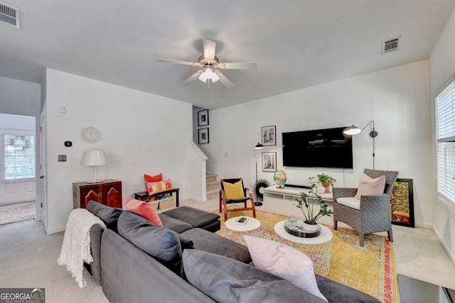 living room featuring ceiling fan and light carpet